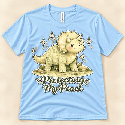 Baby Blue Bella Canvas 3001 Protecting My Peace graphic tee featuring a cute Triceratops and positive self care message from New Chapter Tees, a California small business.