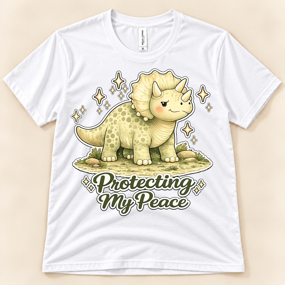 White Bella Canvas 3001 Protecting My Peace dinosaur graphic tee featuring a cute Triceratops and motivational self care saying from New Chapter Tees, a California small business.