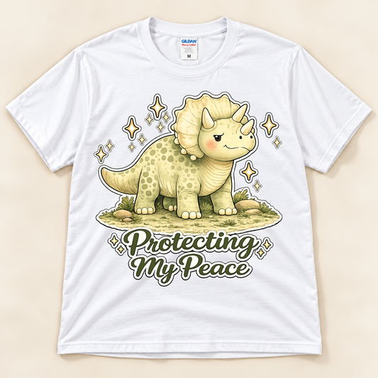 White Gildan 5000 Protecting My Peace dinosaur graphic tee featuring a cute Triceratops, sparkling details and positive self care message from New Chapter Tees, a California small business.