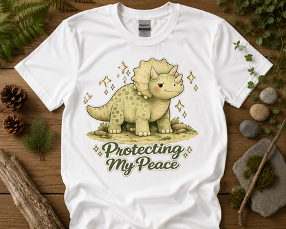Protecting My Peace triceratops graphic tee on white Gildan 5000 unisex shirt with cozy woodland dinosaur aesthetic by New Chapter Tees