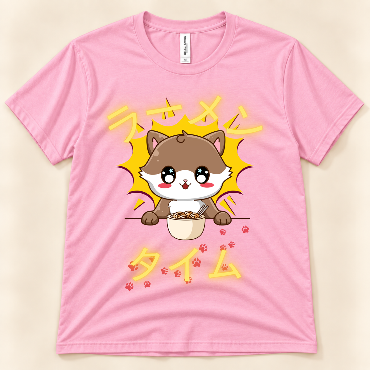 Pink Bella Canvas 3001 kawaii cat ramen shirt featuring a cute brown cat eating noodles with Japanese Ramen Time artwork.
