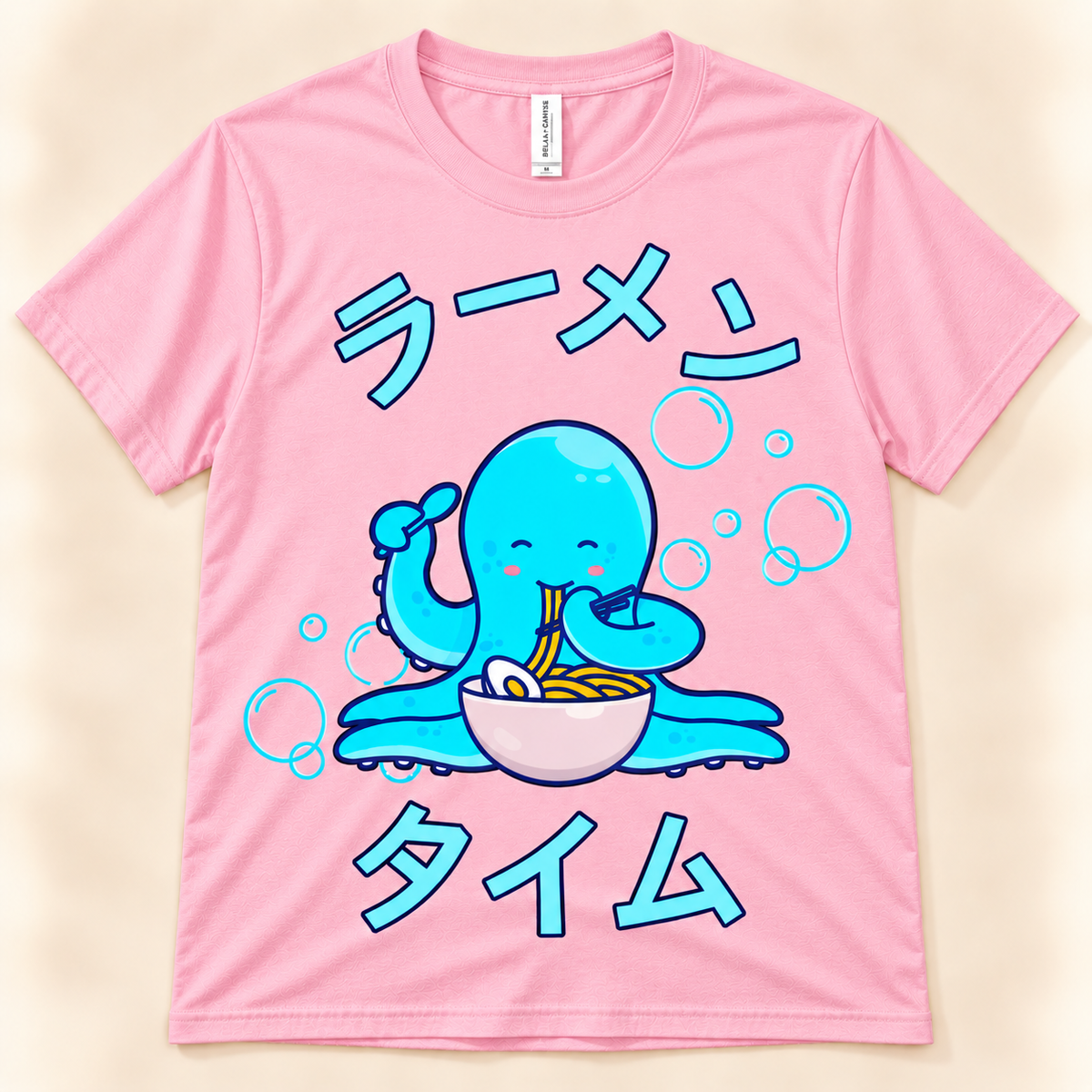 Pink soft graphic tee featuring a cute blue octopus eating ramen with Japanese Ramen Time artwork.