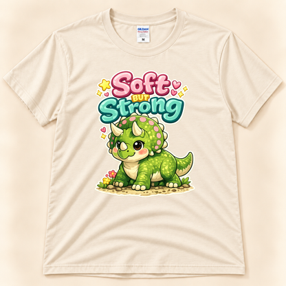 Soft But Strong triceratops graphic tee in Natural by New Chapter Tees, a California small business, featuring a cute green dinosaur design.