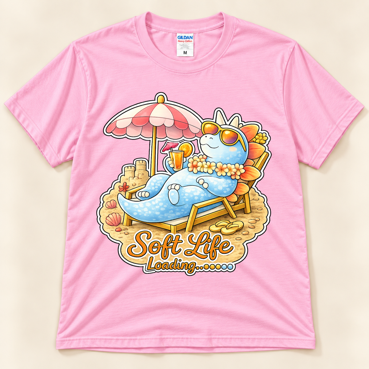 Light Pink Gildan 5000 Soft Life Loading dinosaur tee featuring a cute blue Stegosaurus enjoying a relaxing tropical beach day from New Chapter Tees, a California small business.