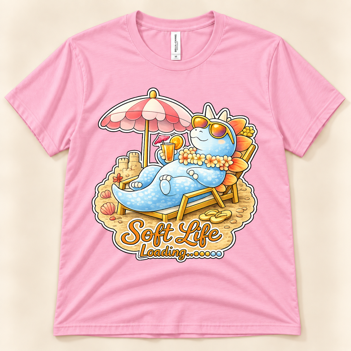 Pink Bella Canvas 3001 Soft Life Loading graphic tee featuring a cute blue Stegosaurus enjoying a relaxing beach vacation from New Chapter Tees, a California small business.
