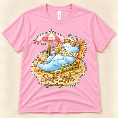 Pink Bella Canvas 3001 Soft Life Loading graphic tee featuring a cute blue Stegosaurus enjoying a relaxing beach vacation from New Chapter Tees, a California small business.