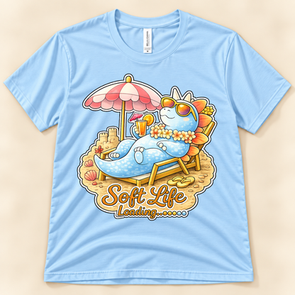 Baby Blue Bella Canvas 3001 Soft Life Loading graphic tee featuring a cute Stegosaurus relaxing on the beach from New Chapter Tees, a California small business.