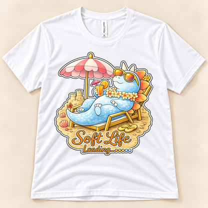 White Bella Canvas 3001 Soft Life Loading dinosaur graphic tee featuring a cute Stegosaurus relaxing under a beach umbrella from New Chapter Tees, a California small business.