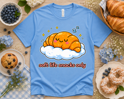 Columbia blue Bella Canvas 3001 Soft Life Snacks Only croissant graphic tee bakery flatlay