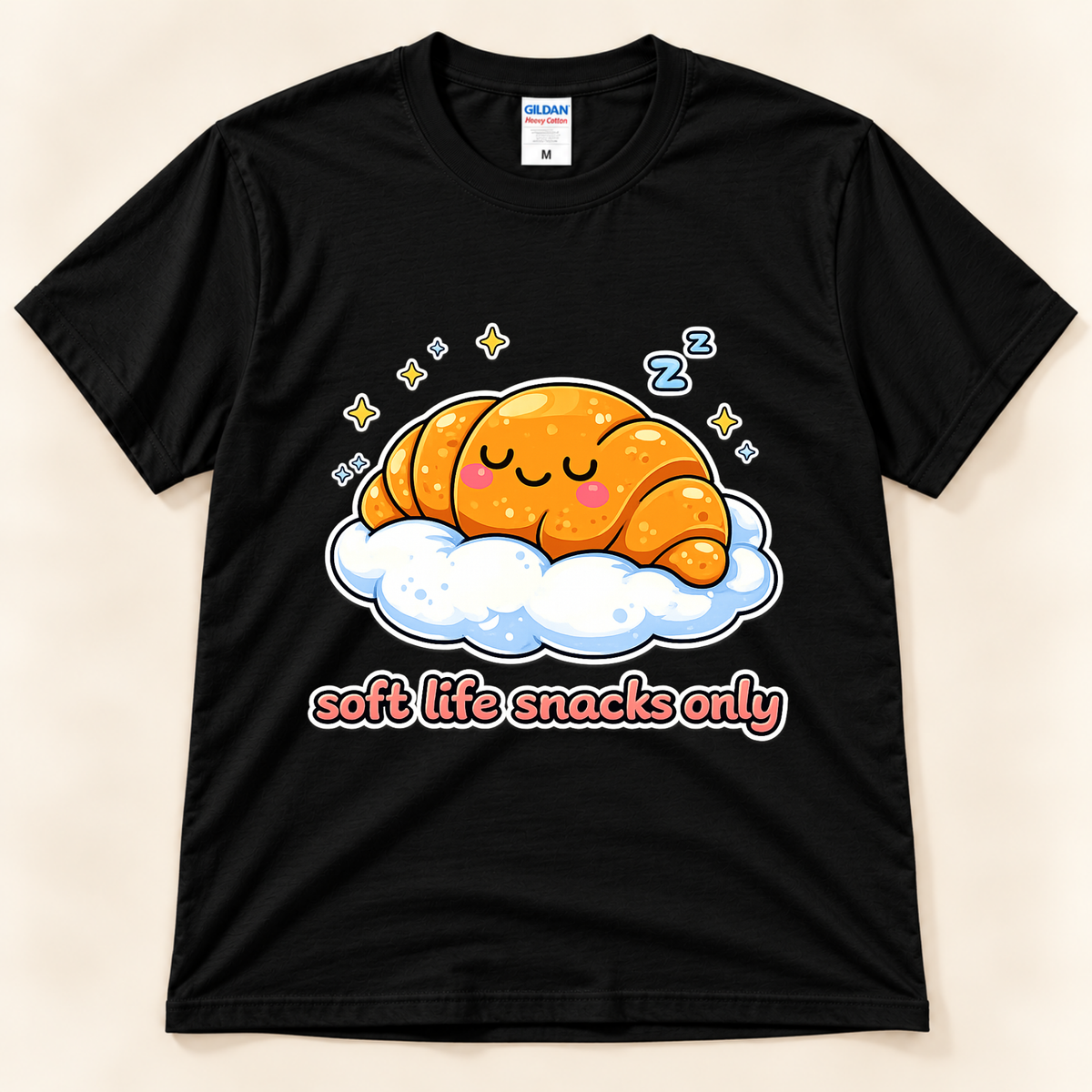 Black Gildan 5000 croissant graphic tee featuring a kawaii sleeping pastry with pink cheeks, fluffy cloud, stars, and Soft Life Snacks Only lettering from New Chapter Tees, a California small business.
