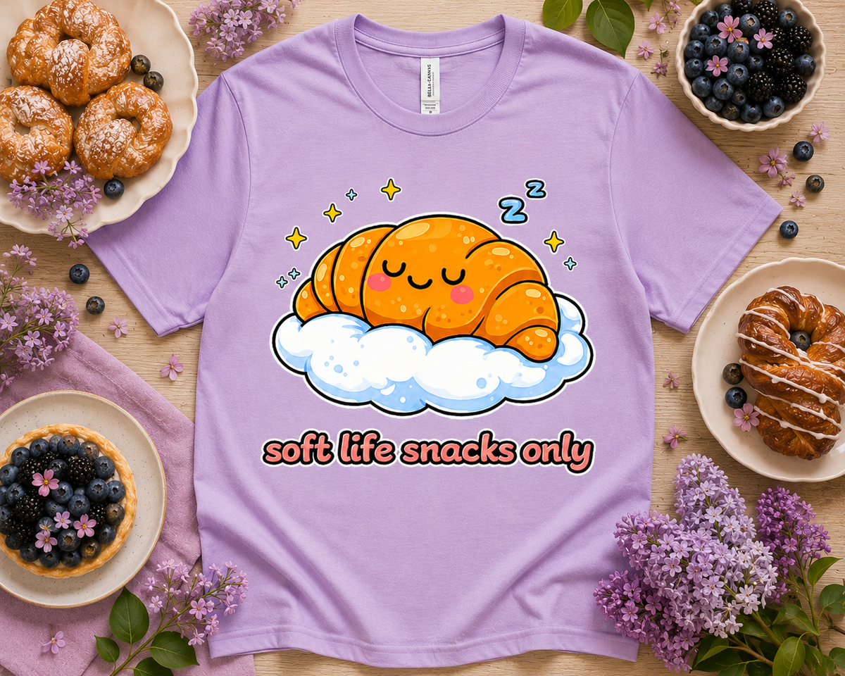 Orchid Bella Canvas 3001 Soft Life Snacks Only croissant graphic tee with pastries and flowers