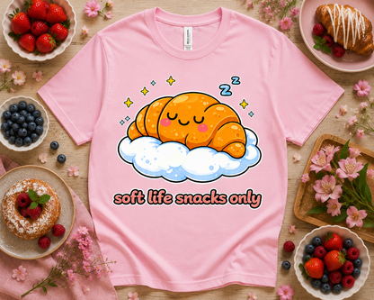 Pink Bella Canvas 3001 Soft Life Snacks Only cute croissant graphic tee with bakery flatlay