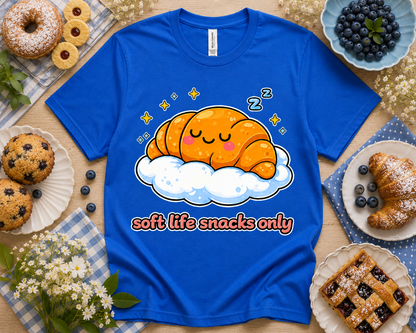 True royal Bella Canvas 3001 Soft Life Snacks Only croissant graphic tee cozy bakery flatlay