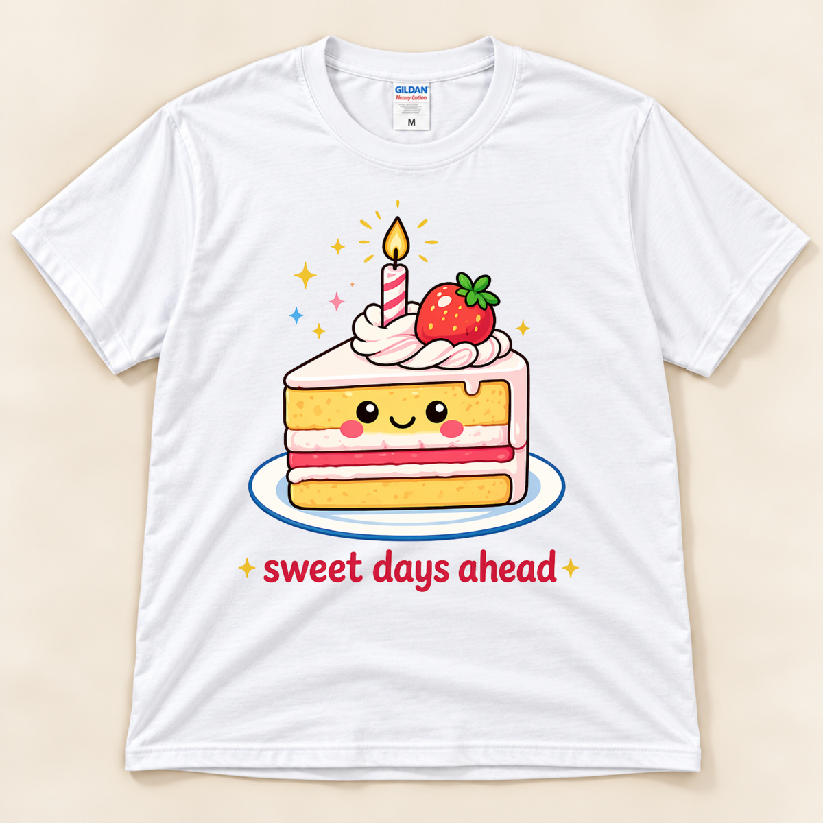 White Gildan 5000 kawaii cake shirt featuring a smiling strawberry cake slice with pink frosting, a lit birthday candle, colorful sparkles, and Sweet Days Ahead lettering from New Chapter Tees, a California small business.