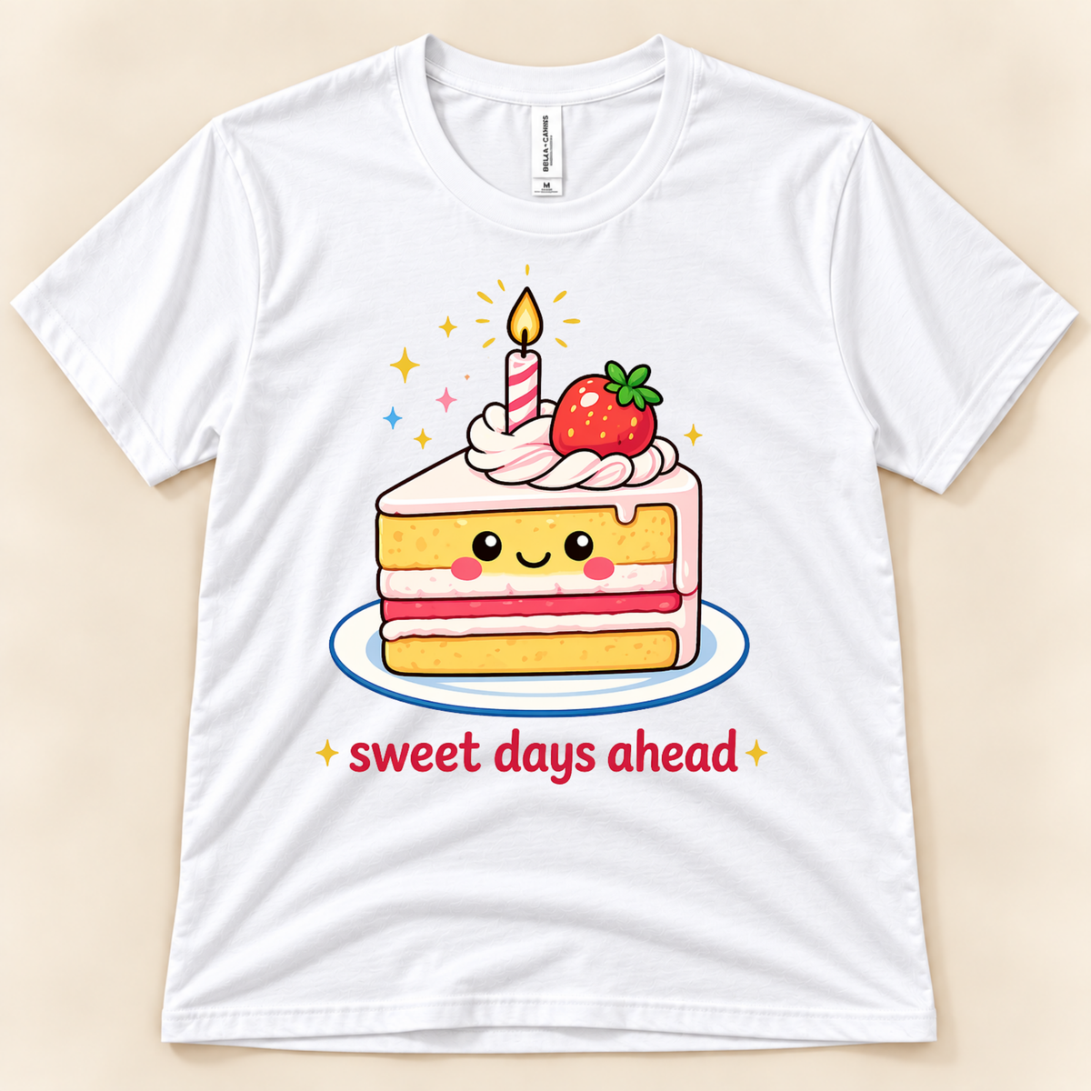 White Bella Canvas 3001 kawaii strawberry cake shirt featuring a smiling slice of layered cake, pink frosting, birthday candle, sparkles, and Sweet Days Ahead lettering from New Chapter Tees, a California small business.
