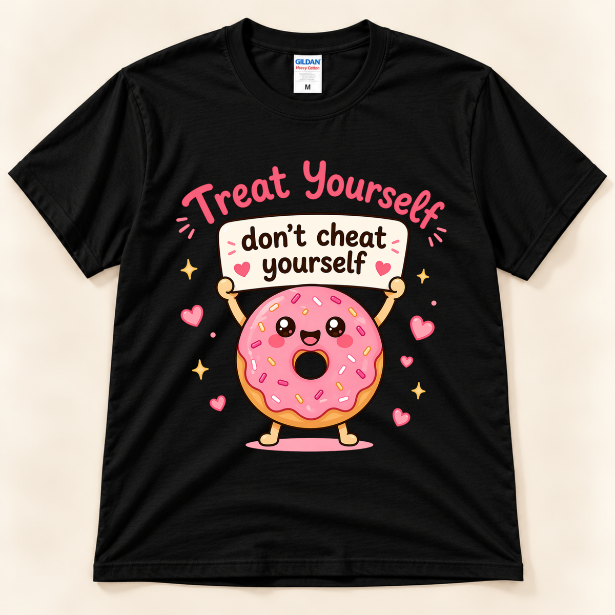 Black Gildan 5000 kawaii donut graphic tee featuring a smiling pink sprinkled donut holding a Treat Yourself Don’t Cheat Yourself sign with floating hearts and sparkles, from New Chapter Tees, a California small business.