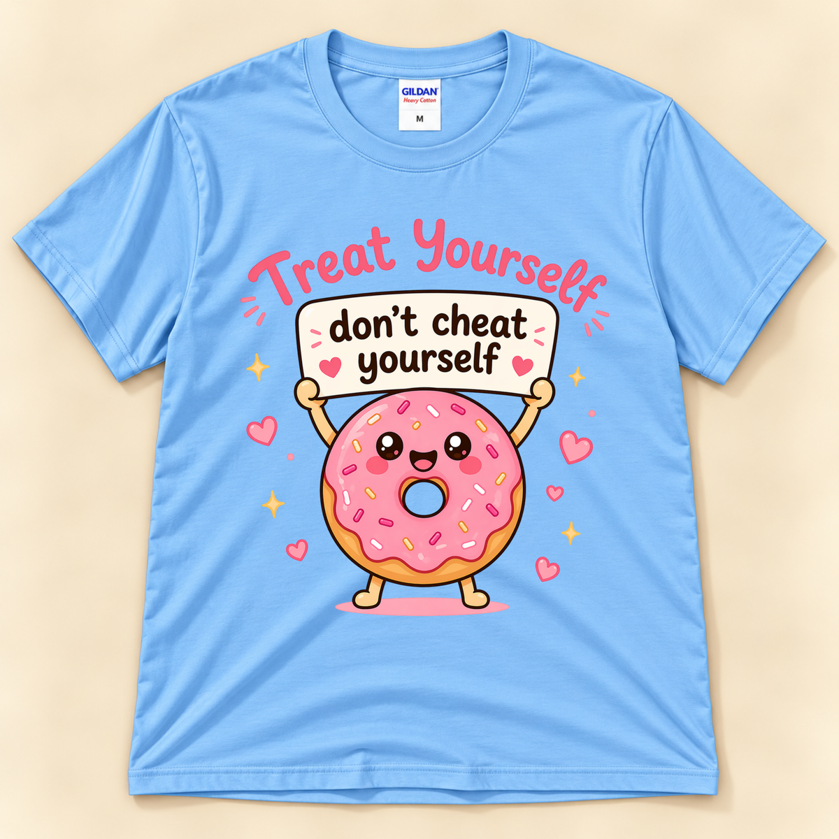 Carolina Blue Gildan 5000 cute foodie graphic tee featuring a happy pink frosted donut with sprinkles, hearts, and a Treat Yourself Don’t Cheat Yourself message from New Chapter Tees, a California small business.