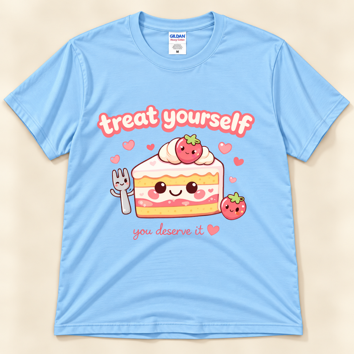 Light Blue Gildan 5000 kawaii strawberry cake graphic tee featuring a smiling layered dessert, adorable strawberries, pink hearts and Treat Yourself You Deserve It saying from New Chapter Tees, a California small business.