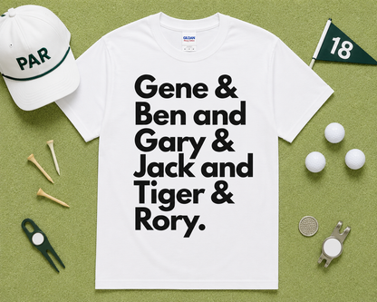 White Gildan 5000 golf graphic t shirt flatlay featuring Gene Ben Gary Jack Tiger Rory design with golf accessories on light green grass, funny golfer gift, unisex golf apparel, USA golf lifestyle clothing.