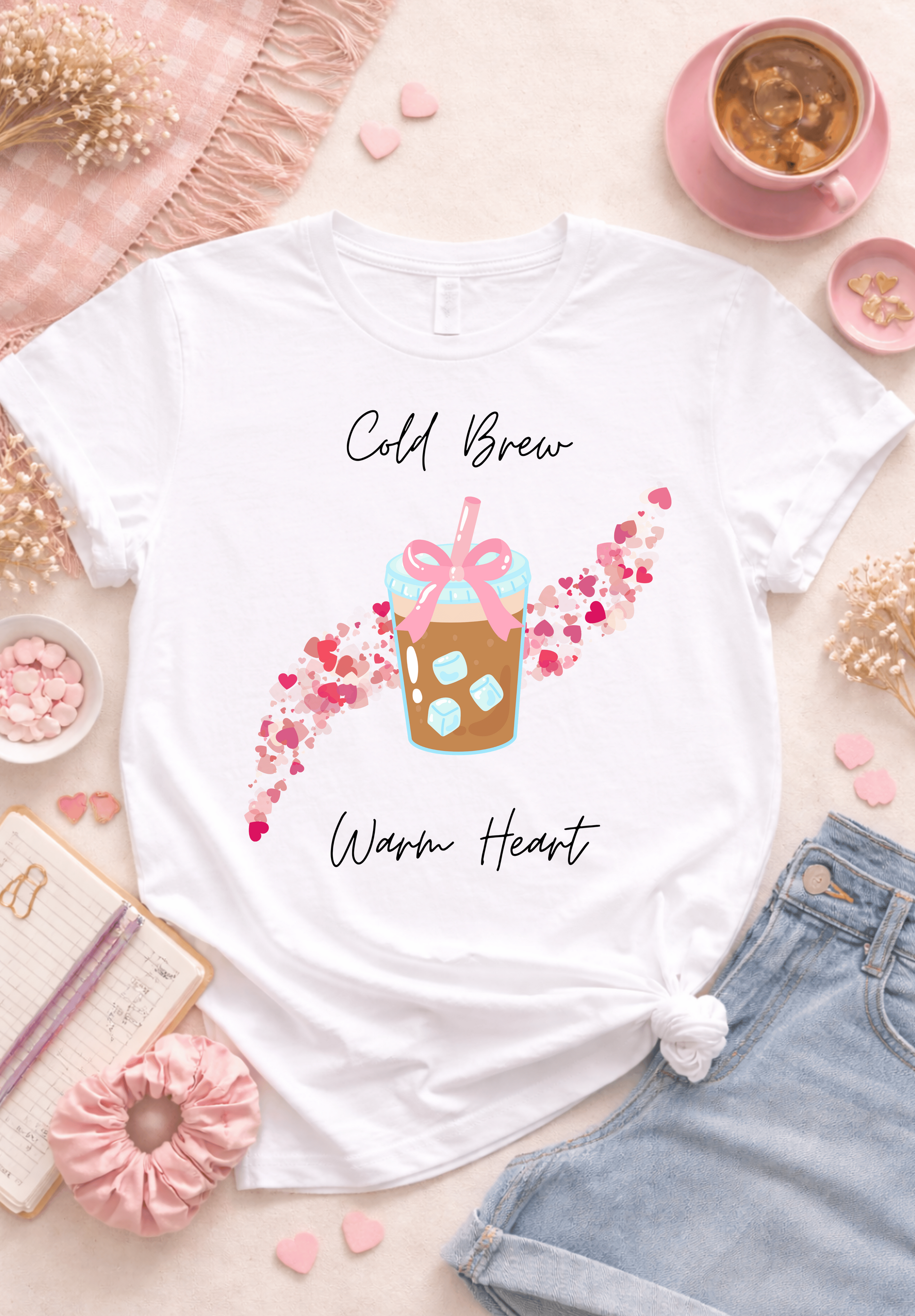 Cold brew warm heart coffee graphic tee flatlay, cute iced coffee shirt aesthetic with pink hearts design