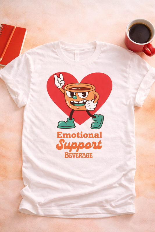 Emotional Support Beverage coffee graphic tee on white shirt with retro coffee cup character and heart design styled in neutral flat lay for coffee lovers