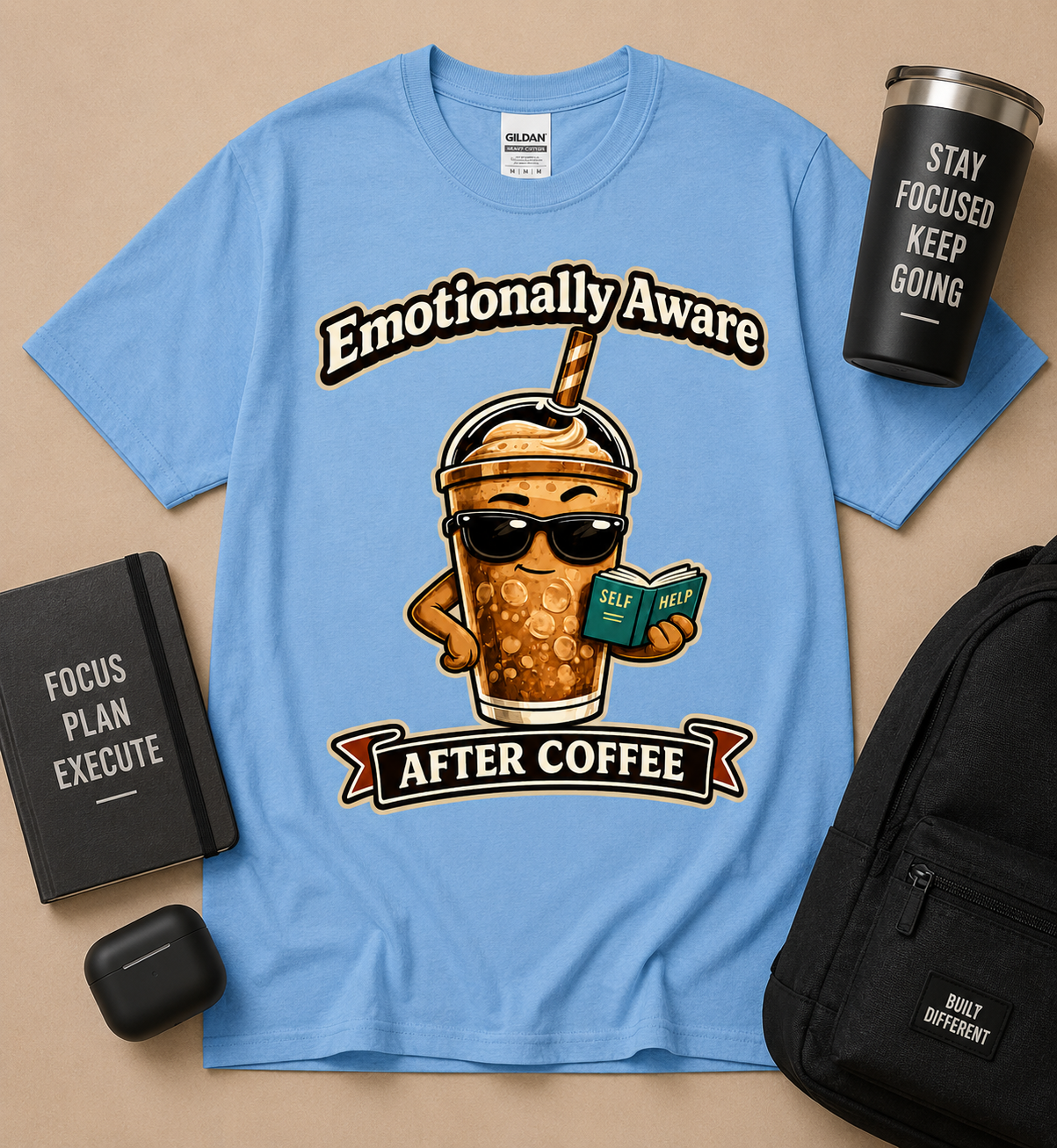 Emotionally Aware After Coffee funny coffee lover graphic tee on Carolina Blue Gildan shirt featuring iced coffee character reading self help book for caffeine lovers