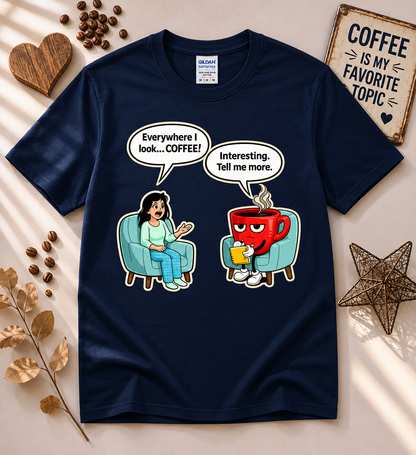 Funny coffee lover graphic tee in navy featuring a therapy session cartoon with a coffee addict saying everywhere I look coffee and a coffee cup therapist responding tell me more, humorous caffeine lover shirt from New Chapter Tees.