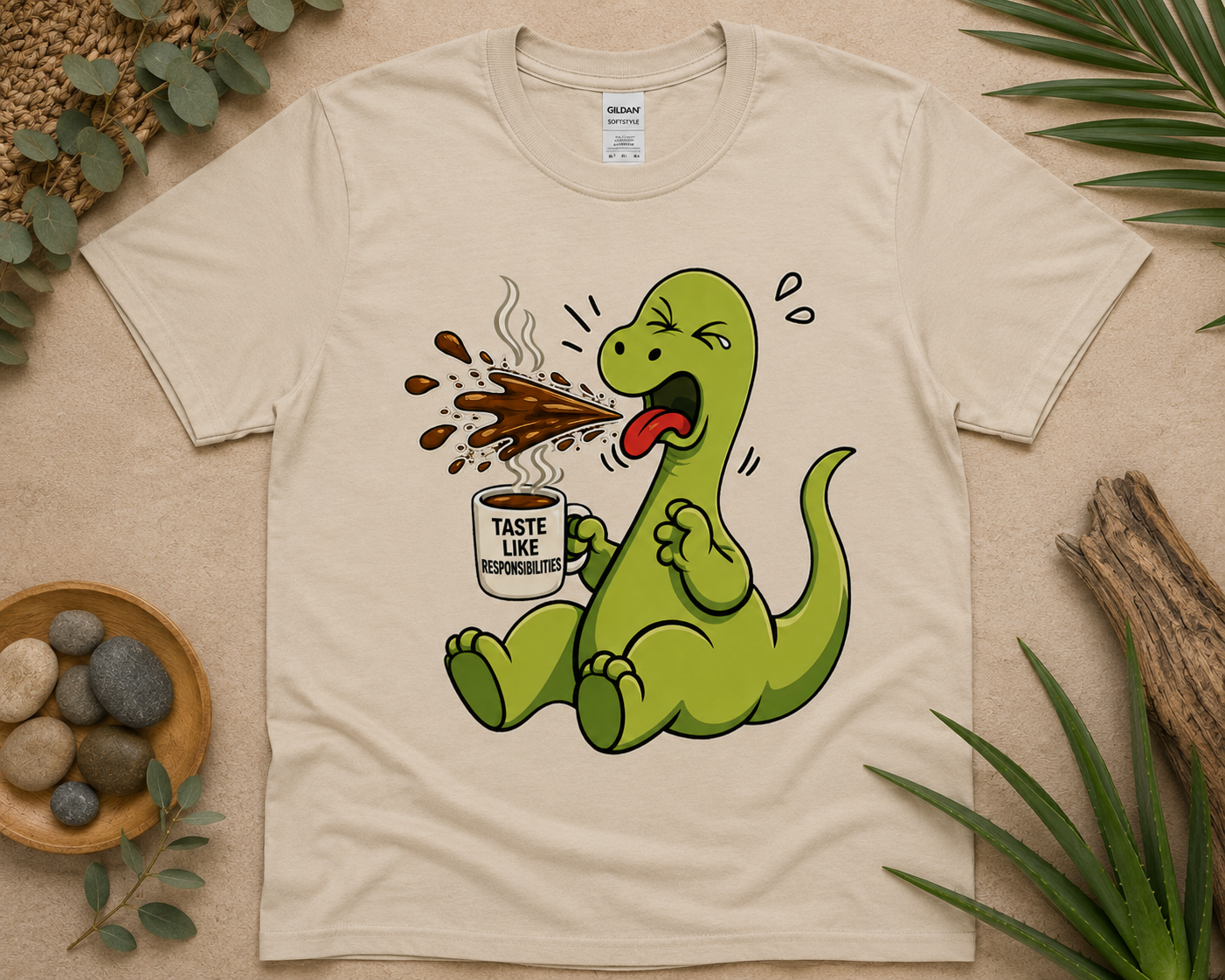 Funny coffee dino graphic shirt on sand Gildan tee with warm neutral flat lay and cute dinosaur coffee artwork