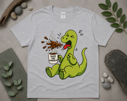 Funny coffee dinosaur graphic tee on sport grey Gildan shirt with cozy relaxed styling and caffeine humor design