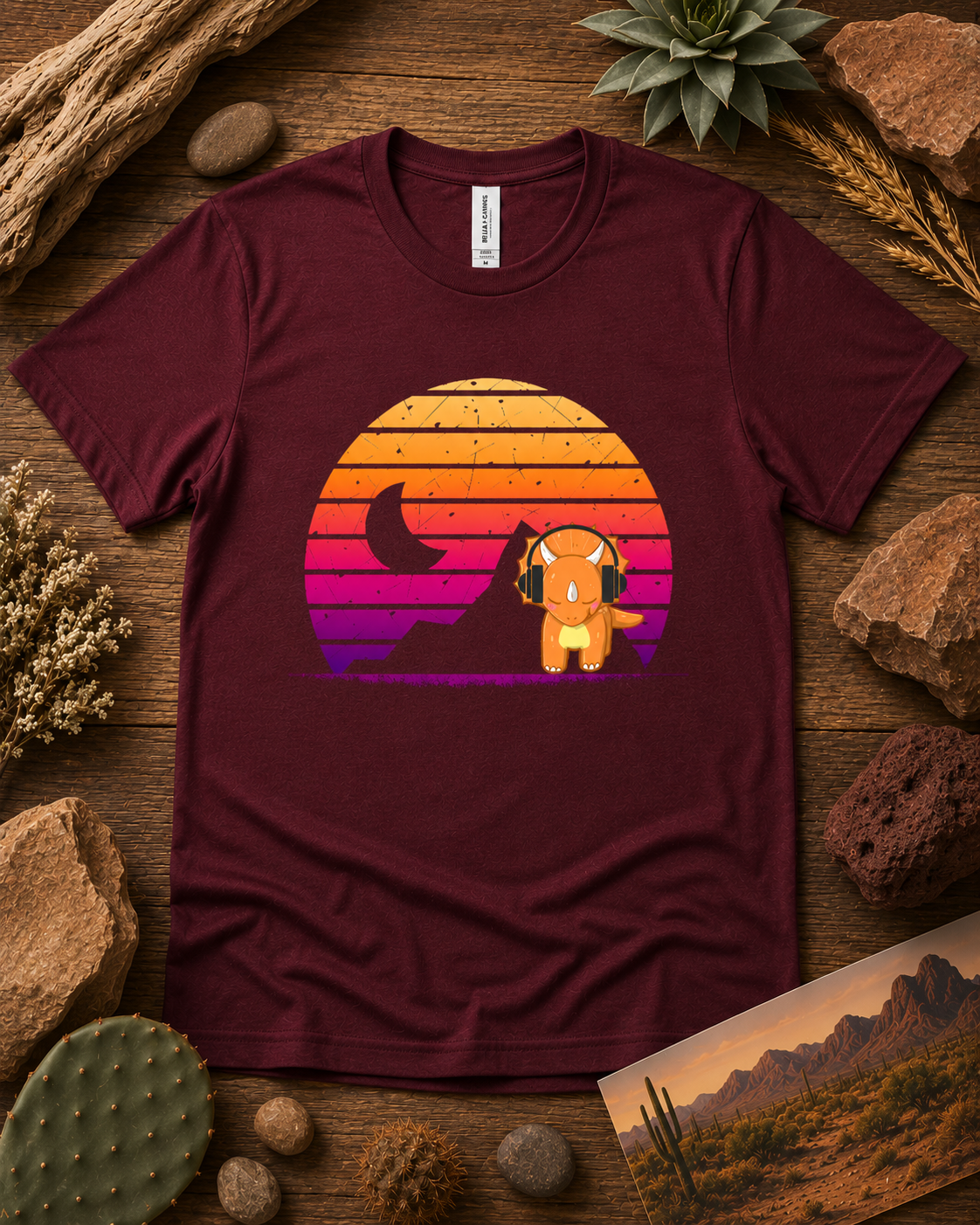Cute retro triceratops headphones sunset dinosaur shirt on maroon Bella Canvas 3001 premium soft tee