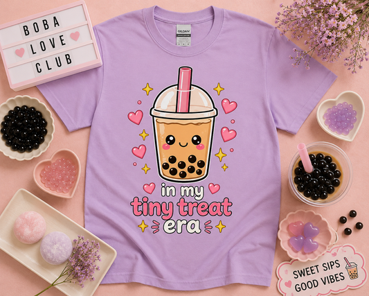 Cute kawaii bubble tea shirt in orchid purple featuring in my tiny treat era design with pink hearts and pastel boba aesthetic flat lay styled for soft girl fashion and cozy café lovers by New Chapter Tees USA