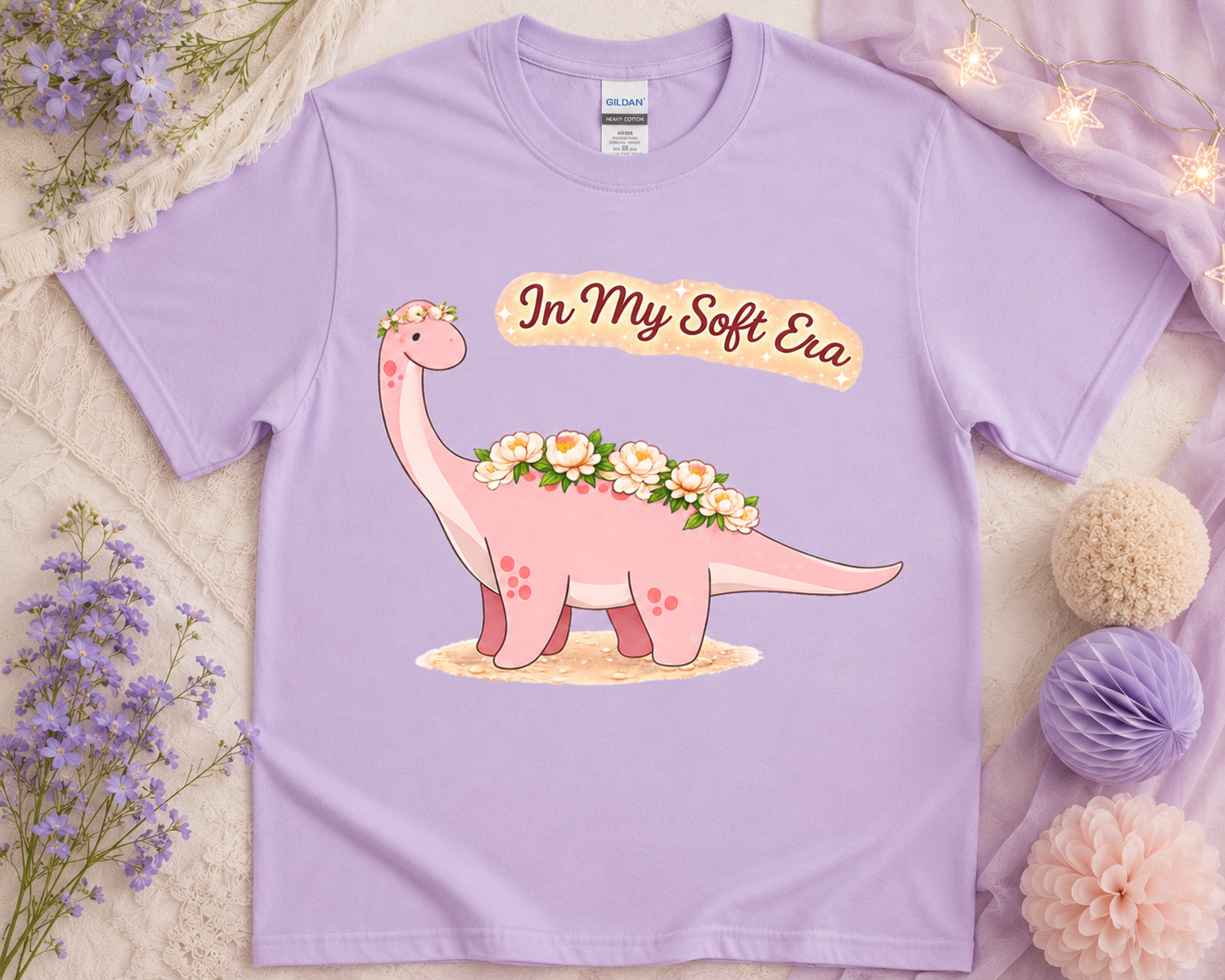 Soft life dinosaur graphic tee on orchid Gildan shirt with pastel floral aesthetic flatlay