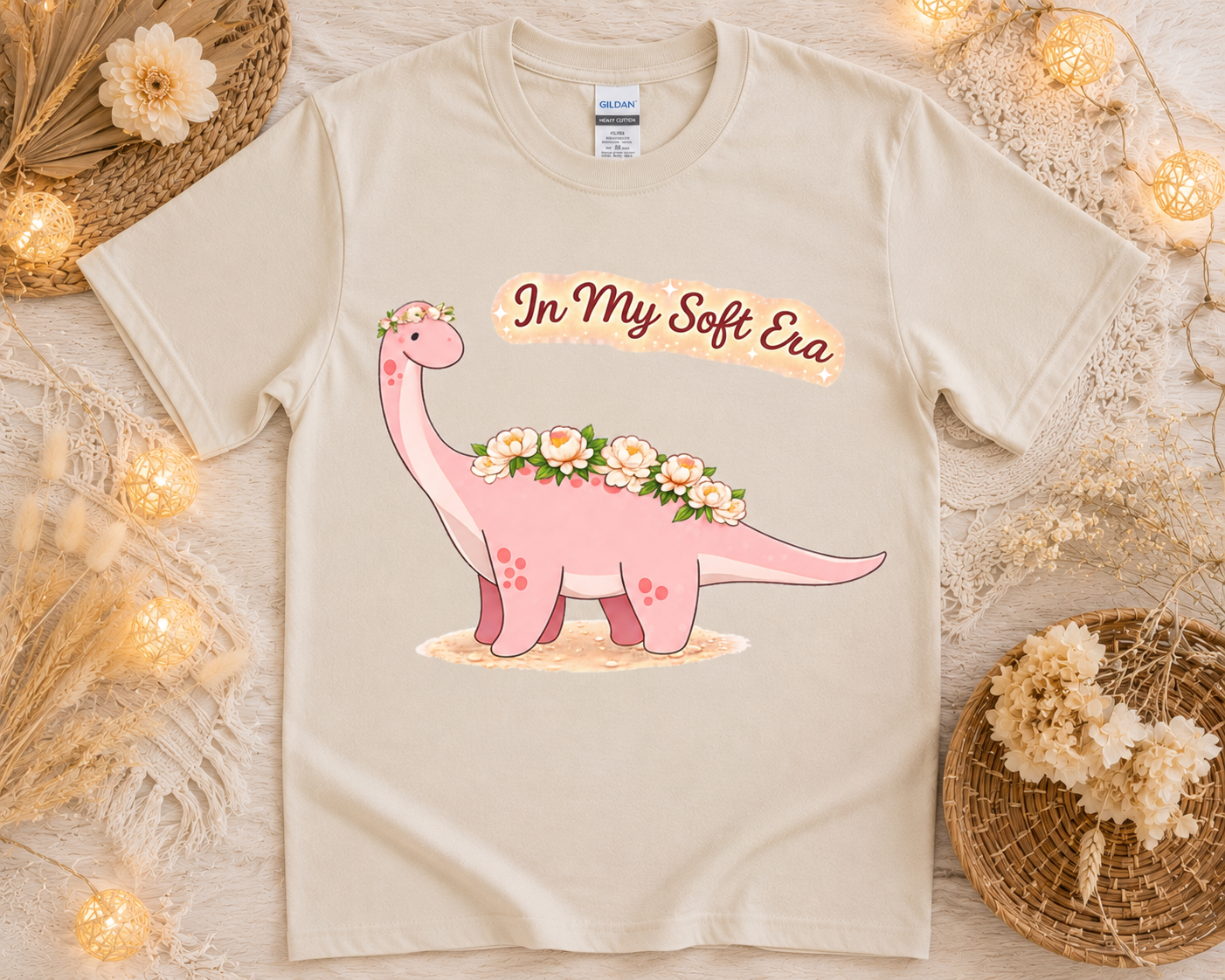 Cozy cottagecore dinosaur graphic tee on sand Gildan shirt with soft floral aesthetic props