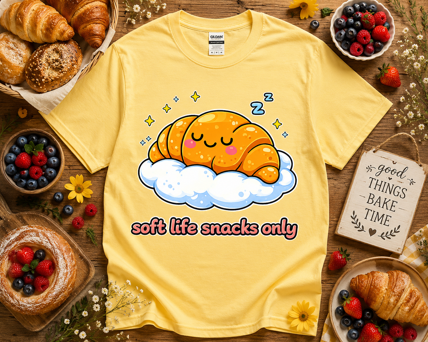 Cute yellow bakery graphic t shirt with sleepy croissant cloud artwork and soft life snacks only text on daisy yellow Gildan 5000 styled with bakery props and berries for cheerful foodie fashion and kawaii clothing lovers in the USA