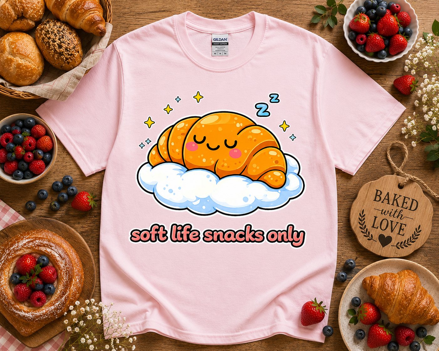 Cute kawaii croissant bakery graphic tee on light pink Gildan 5000 shirt with soft life snacks only design flat lay styled with pastries berries and cozy bakery aesthetic perfect for women teen girls and foodie gift shoppers in Los Angeles California