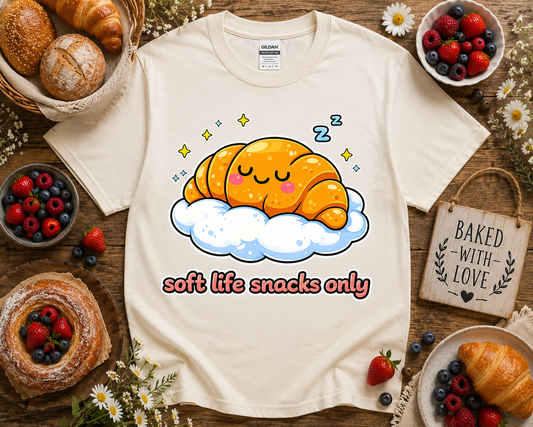 Neutral aesthetic bakery themed croissant graphic t shirt on natural Gildan 5000 with cozy soft life snacks only artwork and bakery props styled for cute foodie fashion lovers and small business boutique shoppers in California