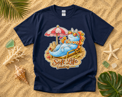 Soft Life Stegosaurus dinosaur graphic tee on navy Gildan shirt with tropical beach vacation flatlay cozy dinosaur summer graphic shirt