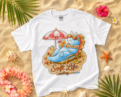 Soft Life Stegosaurus dinosaur graphic tee on white Gildan shirt with tropical beach flatlay perfect for relaxing summer vacation outfit gift