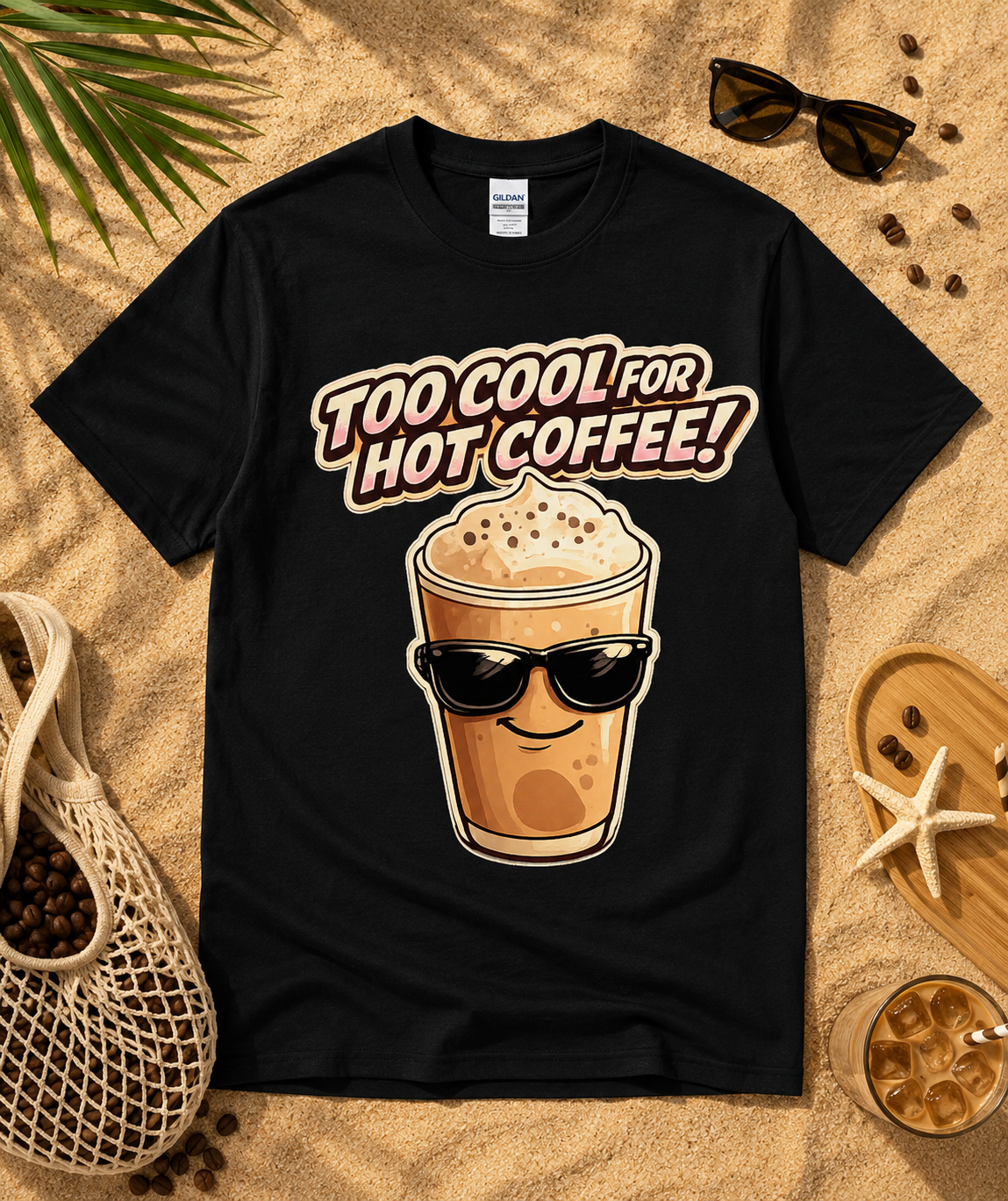 Black Gildan 5000 Too Cool For Hot Coffee graphic tee flat lay on sandy beach with tropical coffee themed accessories fun iced coffee shirt for coffee lovers USA
